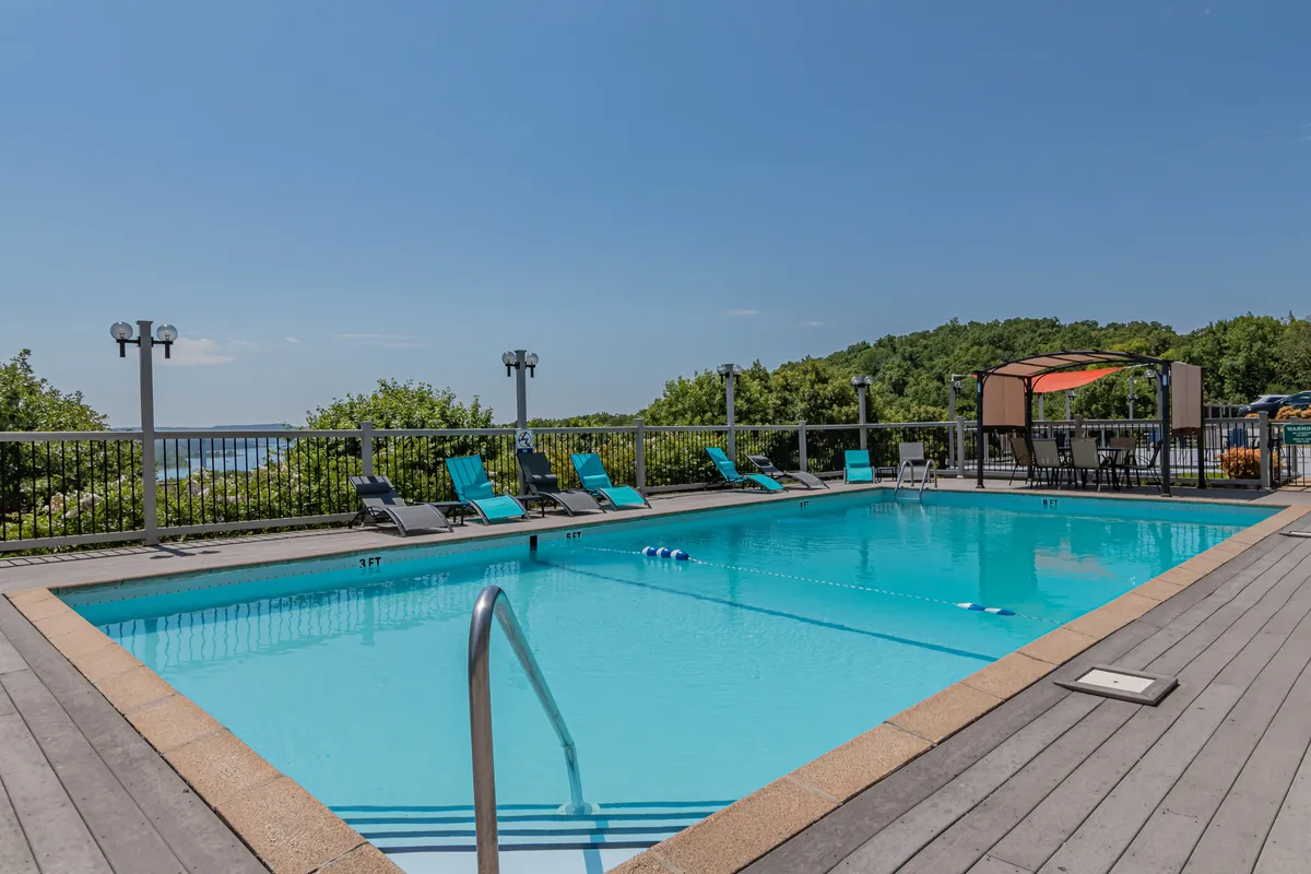 The image showcases a sparkling swimming pool surrounded by lounge chairs, canopy seating, and lush greenery. Groups or families can be imagined socializing, sunbathing, or relaxing poolside, aligning with the leisure and group connection highlighted in the section.